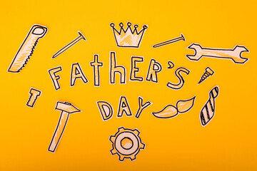 Obraz premium Happy Fathers Day gift tag with top border of tools