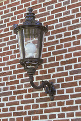 Individual vintage street light against wal