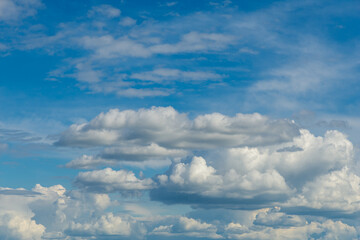 may blue sky with fluffy cumulus rain clouds