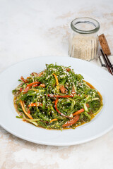 Seaweed and vegetable salad in a white plate