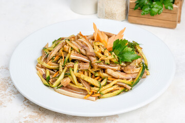 Pork ears salad with vegetables and fresh herbs