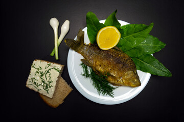 Fried crucians in a pan. Cooking fried fish. A dish of fried crucian carp. Tasty river fish.