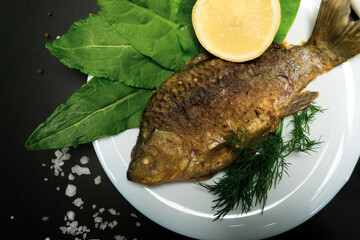 Fried crucians in a pan. Cooking fried fish. A dish of fried crucian carp. Tasty river fish.