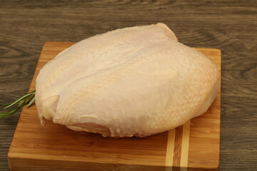 Raw whole chicken breast with skin