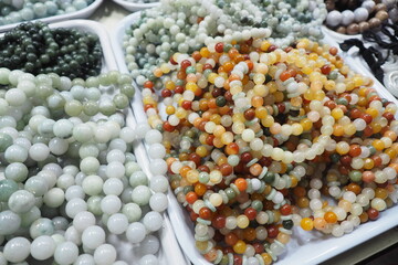 Top view of local colorful stone beads weave bracelets for fashion items and accessories in the market People wear them for good luck and prosperity. Asian and Chinese design jewelry concept
