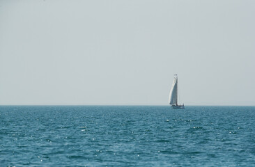 Fototapeta premium Tourists enjoying on a traditional boat with mast and sails in Arabian Gulf on Febrauary 09 , 2018 near Asker, Bahrain