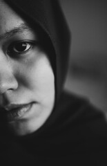 A young Muslim woman looking sad