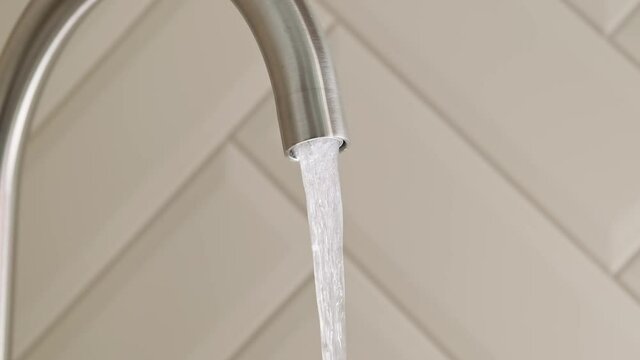 Tap water stop to flow from tap in kitchen in slow motion. Pure water for people hygiene. Close-up shot