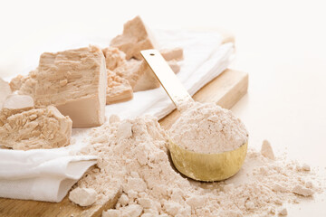 Fototapeta na wymiar Wholegrain flour and fresh yeast on wooden board.