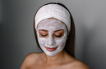 Face peeling mask, spa beauty treatment, skincare. Woman getting facial care by beautician at spa salon