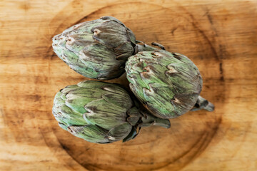 artichokes isolated on wood table