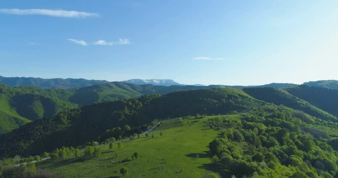 Green meadows and pastures in the mountains aerial drone view
