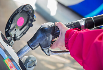 woman pumping gasoline