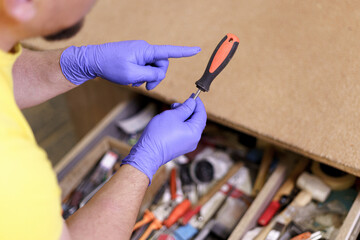 Carpenter man choosing a tool to work on wood out of the toolbox