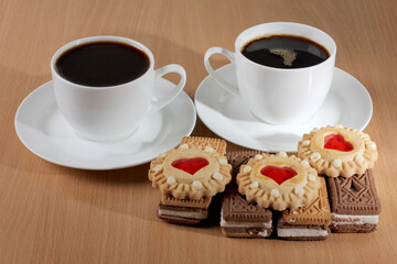 Cup of coffee and sweet cookies on a wooden kitchen table