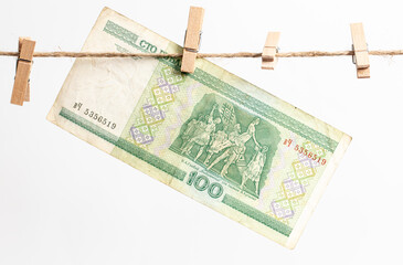 Belarusian rubles hang on a rope on a white background.