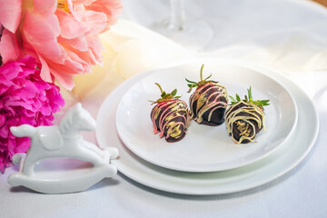 Chocolate covered strawberry on plate