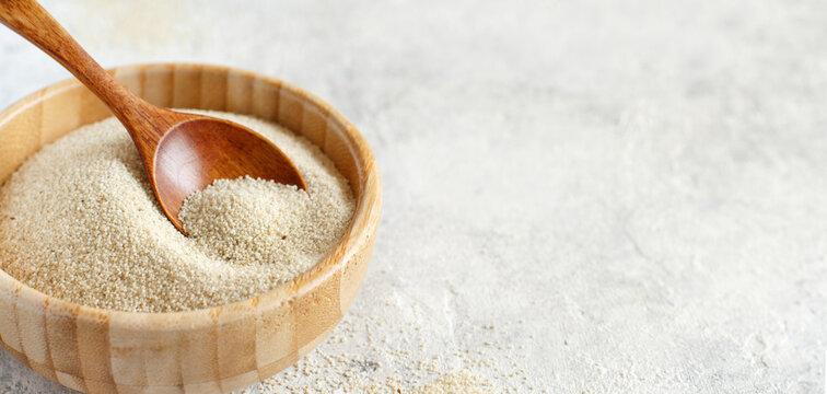 Raw fonio seeds in a bowl with a spoon