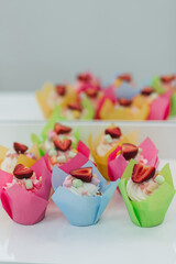 sweet cupcakes muffins with fresh strawberries and white cream