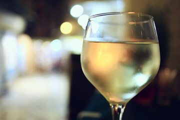glass white wine restaurant interior, abstract evening dinner with alcohol at the bar