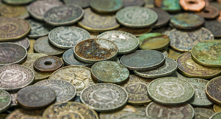 Pile of rusted old coins abandoned in an old lost crate