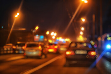 abstract blurred view of the night city from a car window, traffic in the city