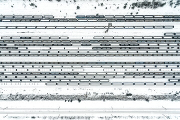 Cargo train terminal, railway hub in winter aerial drone photo