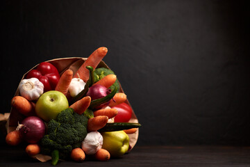 The original unusual edible bouquet of vegetables and  on a dark wood with copy space
