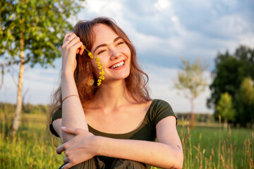 Portrait of a young smiling woman in the park.