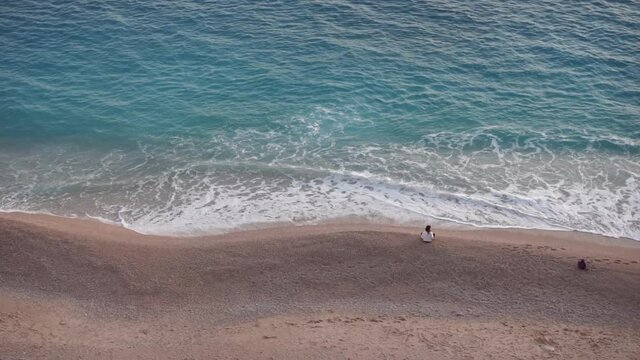 KAS, ANTALYA, TUKEY, Spring: Kaputas beach and a woman figure, handheld.