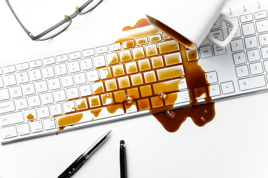 Cup of coffee spilled on office desk concept of careless clumsy or accident