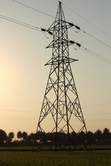 high voltage power lines in outskirts of davangere at sunset