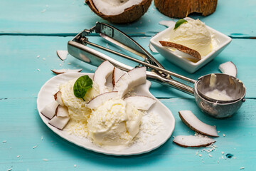 Lactose free coconut ice cream. Special spoon, halves of fruit, flakes