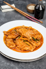 Sweet and sour pork in a white round plate