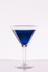 Glass of blue martini on a white background