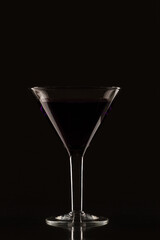 Glass of martini on a black background