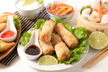 assorted of asian food with spring roll, soy sauce, dumpling