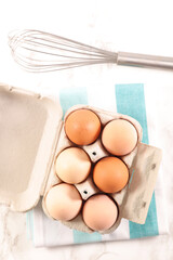 egg in box with whisk
