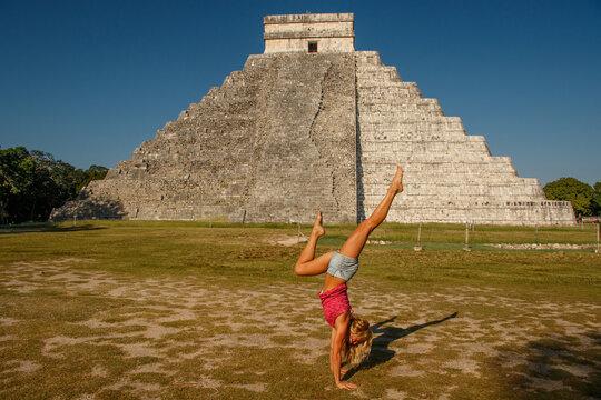 Handstand in front of famous Kukulkan pyramid in Chichen Itza, Mexico