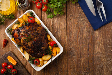 Roasted whole shoulder, with potatoes, peppers and tomatoes. Marinated in white wine.