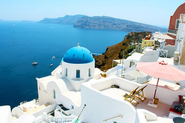 Beautiful Santorini view in Greece. Blue sea and white buildings. One of the most popular icons of Santorini.
