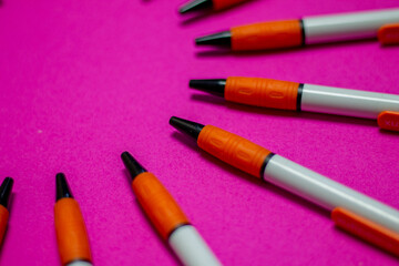 Group of pens on a coloured background, concept of an equal group