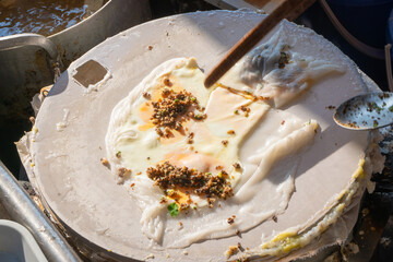 Banh Cuon in Vietnamese language steamed rice rolls on pot favorite delicious traditional food of Vietnam
