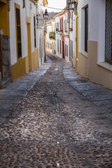 Obraz premium Street with white and yellow facades of the city of Cordoba