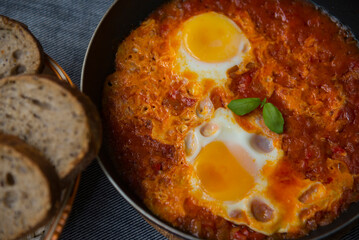 Shakshouka - eggs in tomato sauce, served in a frying pan