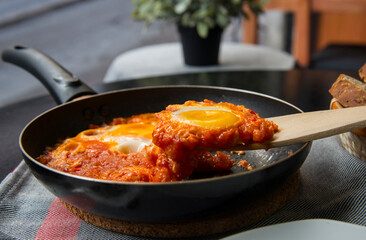 Shakshouka - eggs in tomato sauce, served in a frying pan