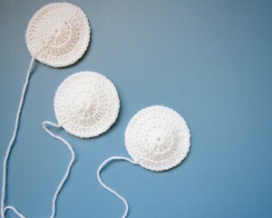 white hand made crochet circles on blue background 