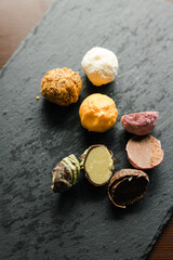 colored candy truffle on a black plate