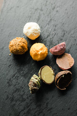 colored candy truffle on a black plate