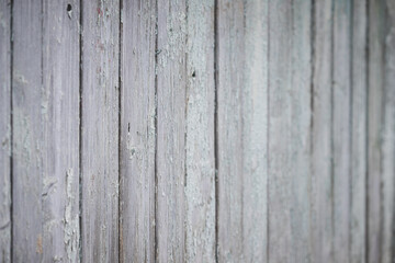 Naklejka premium Closeup of an old texture of a weathered wooden wall painted in turquoise color. Aged wooden plank fence made of flat table boards. Copy space. Selective focus